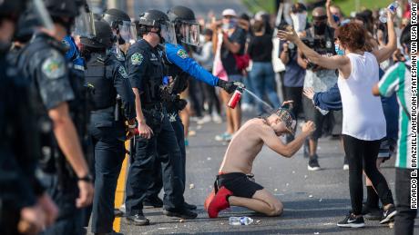 May 30, 2020; Austin, TX, USA; APD officer sprays pepper spray at a protester northbound lane of Interstate 35 freeway in Austin Texas on Saturday, May 30, 3030. Demonstrators protest over the police killing of George Floyd  Saturday, May 30, 2020.  Mandatory Credit; Ricardo B. Brazziell/American-Statesman-via USA TODAY NETWORK