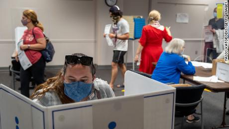 FAIRFAX, VIRGINIA - SEPTEMBER 18: Voters cast ballots, spaced  apart due to covid-19 at the Fairfax Government Center on September 18, 2020 in Fairfax, Virginia. Voters waited up to four hours to early vote in the upcoming 2020 presidential election, polls opened at 8am, and people where in line at 5:45am according to poll workers. (Photo by Tasos Katopodis/Getty Images)