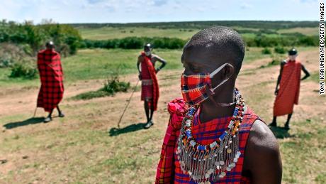 Cultural performers from the Maasai tribe wear cloth masks as they gather outside their manyatta (village) in Talek in the Maasai Mara National Reserve, where their work of performing for visiting tourists has dwindled, in Talek in Maasai Mara, in the Narok county in Kenya, on June 24, 2020. - At the heart of the majestic plains of the Maasai Mara, the coronavirus pandemic has led to economic disaster for locals who earn a living from tourists coming to see Kenya&#39;s abundant wildlife.
Even before the virus arrived in Kenya mid-March, tourism revenues plummeted, with cancellations coming in from crucial markets such as China, Europe and the United States. (Photo by Tony Karumba / AFP) (Photo by TONY KARUMBA/AFP via Getty Images)