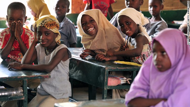 Children pose in a classroom at the Friendship Primary school in Zinder on June 1, 2012. Some 238 schools in the Zinder region benfit from a school cantine program run by the &#39;Programme alimentaire mondial (PAM)&#39; that feed around 43841 children of which 2917 girls. 