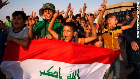 children holding Iraq&#39;s national flag react as Iraqi forces celebrate in the Old City of Mosul on July 9, 2017 after the government&#39;s announcement of the &quot;liberation&quot; of the embattled city. 
Iraq declared victory against the Islamic State group in Mosul on July 9 after a gruelling months-long campaign, dealing the biggest defeat yet to the jihadist group. / AFP PHOTO / FADEL SENNA        (Photo credit should read FADEL SENNA/AFP/Getty Images)