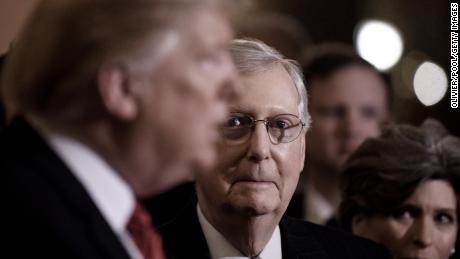 US President Donald Trump (L) talks to the press as Senate Majority Leader Mitch McConnell (R-KY) looks on after the Republican luncheon at the U.S. Capitol Building on January 9, 2019 in Washington, DC. 