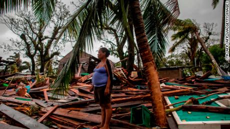 TOPSHOT - A woman waits for people to fix her house after the passage of Hurricane Iota, in Bilwi, Puerto Cabezas, Nicaragua, on November 17, 2020. - Storm Iota has killed at least nine people as it smashed homes, uprooted trees and swamped roads during its destructive advance across Central America, authorities said Tuesday, just two weeks after Hurricane Eta devastated parts of the region. (Photo by STR / AFP) (Photo by STR/AFP via Getty Images)