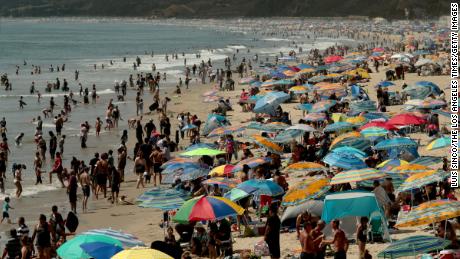 SANTA MONICA, CA - AUG. 15, 2020.:  Beachgoers create a forest of umbrellas as thousands seek refuge in Santa Monica with  temperatures reaching triple digits and beyond in inland valleys and deserts on Saturday, Aug. 15, 2020.  A heatwave caused by a high pressure system over Southern California is expected to last through next week.  (Luis Sinco / Los Angeles Times via Getty Images)