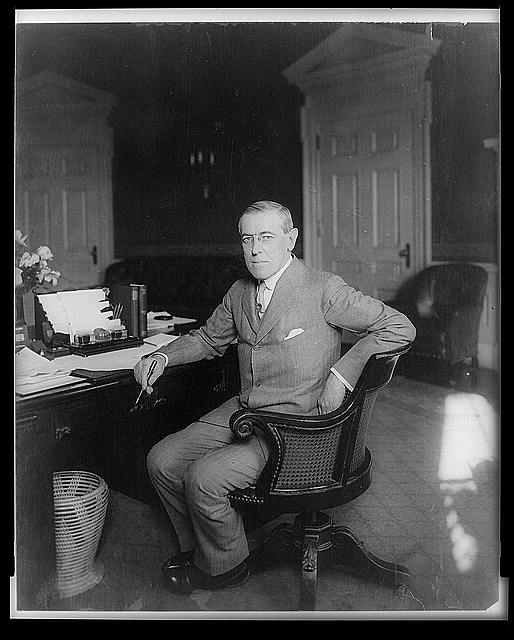 [Woodrow Wilson, full-length portrait, seated at desk, facing slightly left]