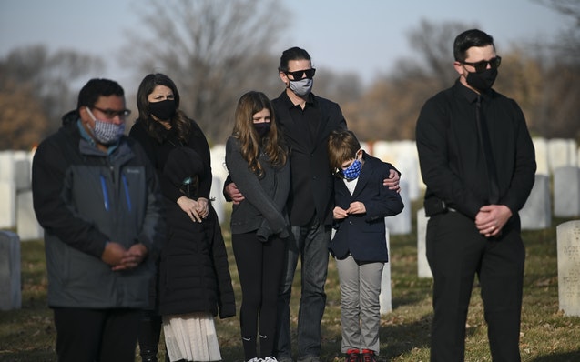 Tony Quinn put his arms around his children, Ryder, 9, and Ruby, 12, at the funeral for their great-grandfather Thursday, Dec. 10 at Fort Snelling Nat