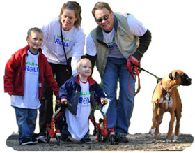 Family with child walking with walker