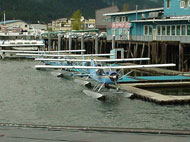 Small commercial float plane docked in marina