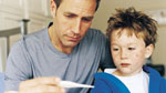 Father Checking Temperature of Son Sick With Chickenpox.