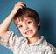 Boy scratching his head.