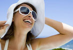 Photograph of woman wearing hat and sunglasses