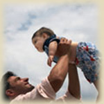 Father holding infant
